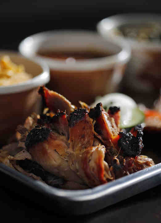 Downtown Sampler with Pulled Pork, Beef Brisk, House Mac and Cheese, House Baked Beans and House Collar Greens at Pecan Penny's in downtown Columbus on June 26, 2018.    (Kyle Robertson / The Columbus Dispatch)